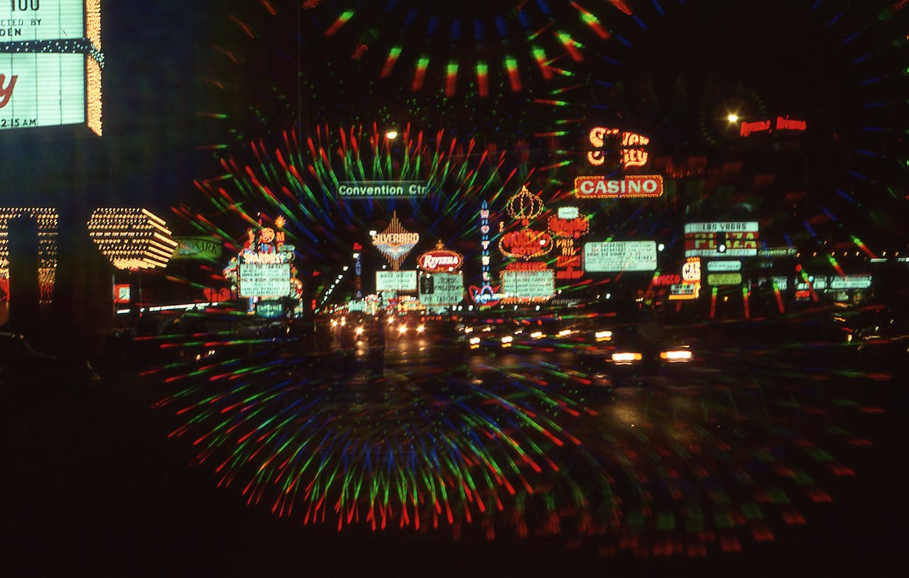 Explore the vibrant neon-lit streets of downtown Las Vegas at night, featuring casinos and bustling nightlife.
